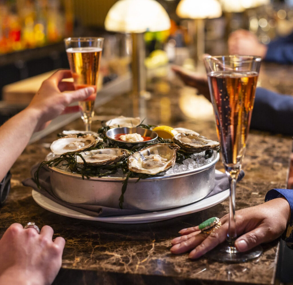 Ocean Prime Restaurant - diners cheers over oysters